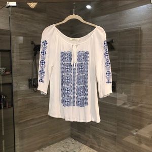 White blouse with blue stitching
